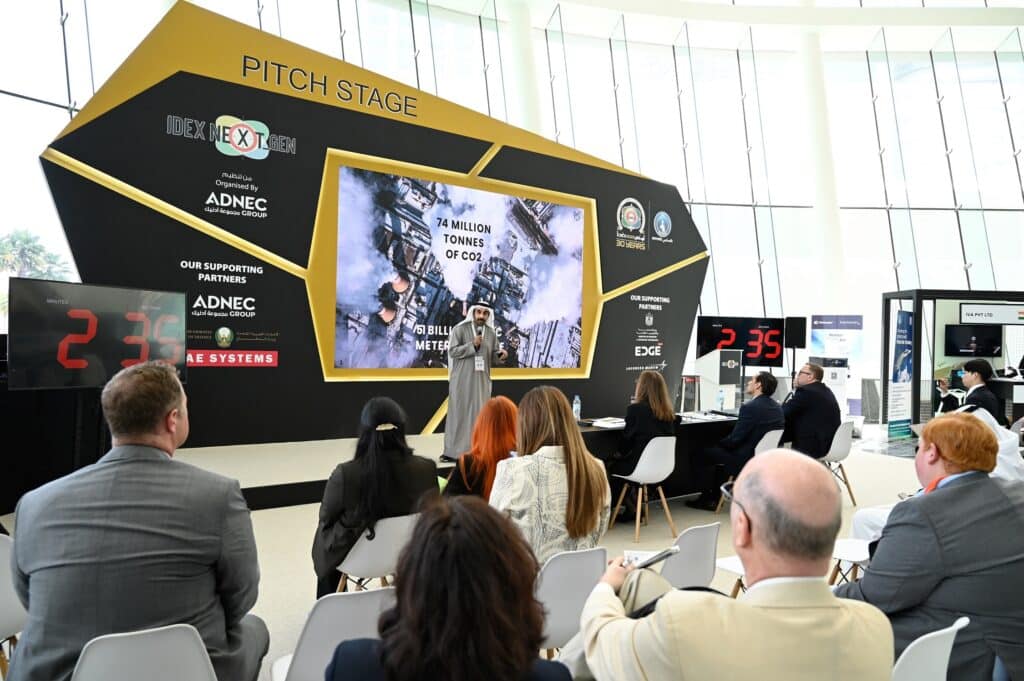 Visitors participating at the pitch stage at the IDEX NEXT GEN stage.